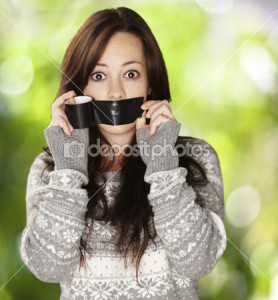 depositphotos_10181534-Portrait-of-scared-girl-being-silenced-by-herself-against-a-natu